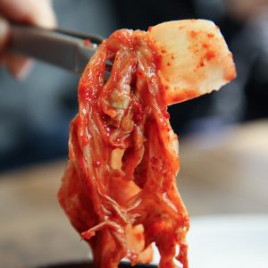 close up of kimchi being served with tongs