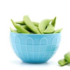 blue bowl overflowing with perfect green sugar snap peas