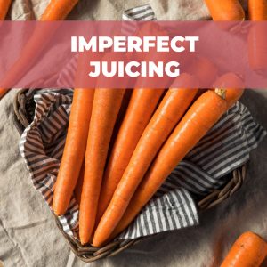 Orange organic carrots in a wicker basket with a banner that reads "imperfect juicing".